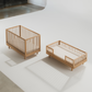 Two wooden cribs on a white floor with a neutral background